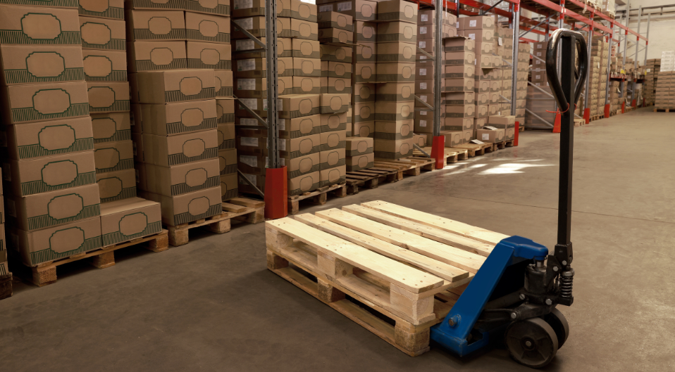 pallet truck in front of stacked pallets