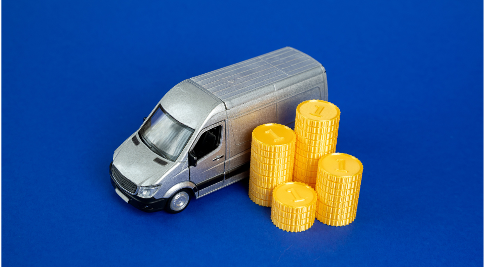 A van sitting next to a stack of gold coins