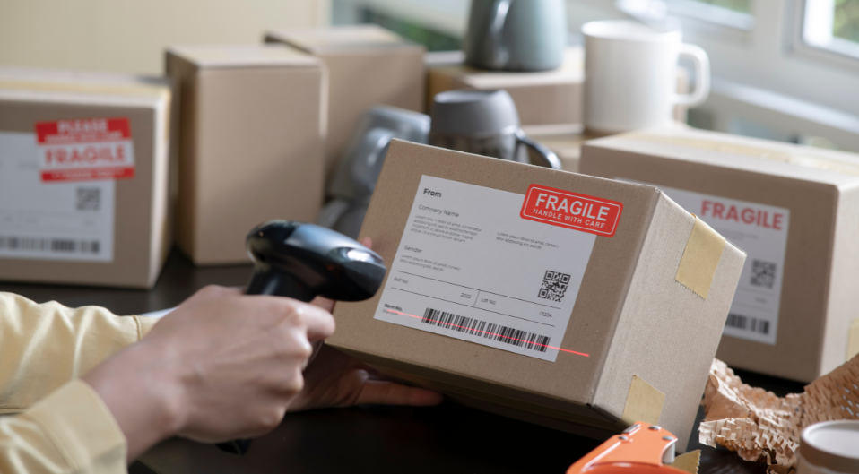 Someone scanning the barcode on a parcel marked as being fragile